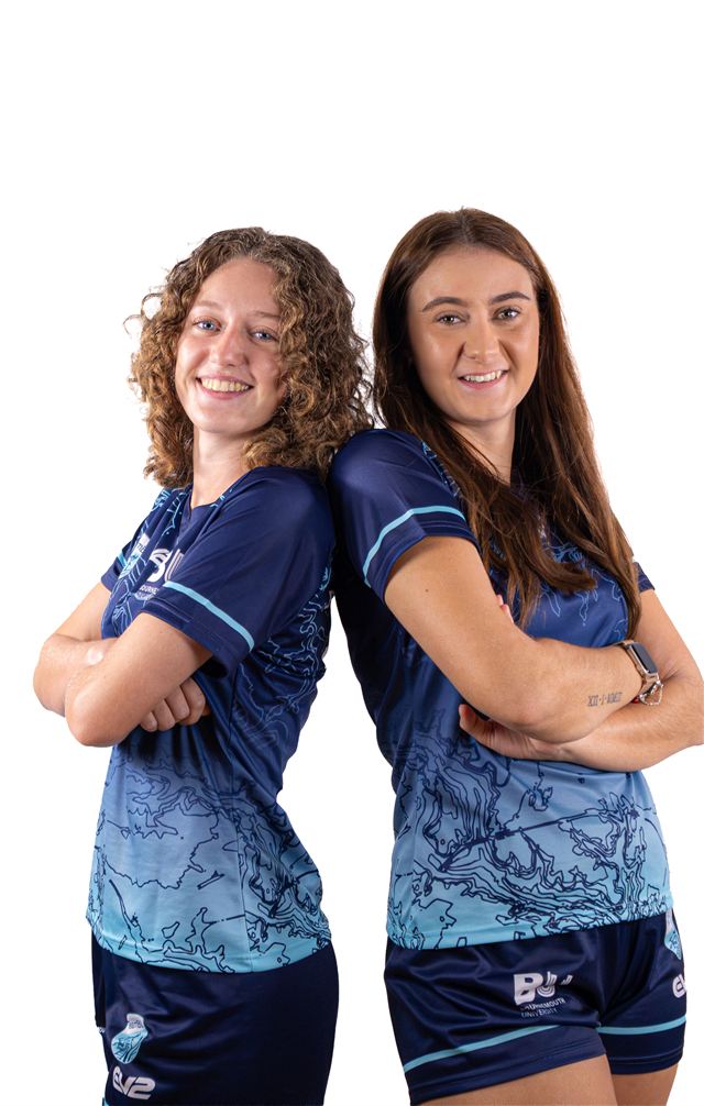 Two players standing back to back with their arms crossed